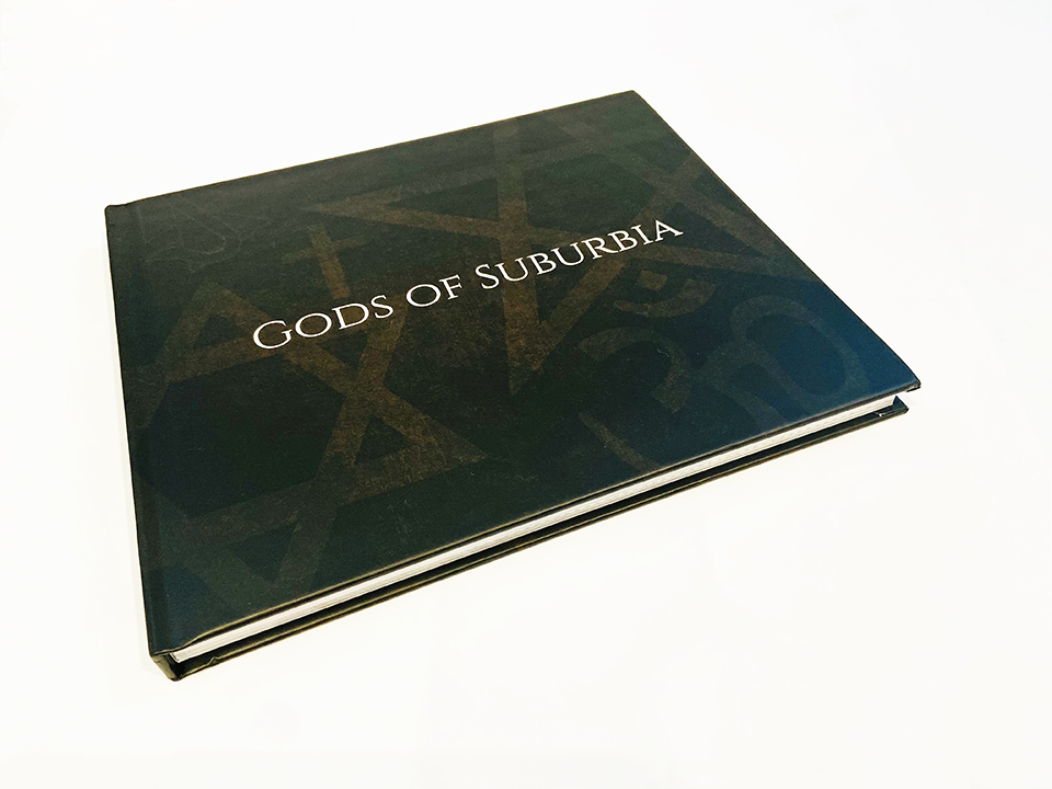 GODS OF SUBURBIA Hard Cover Book